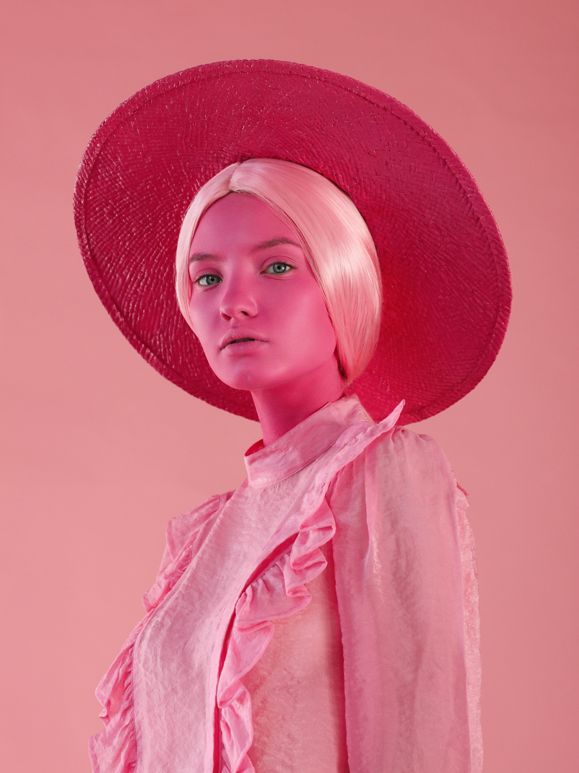 Portrait of young woman in monochrome pink tones